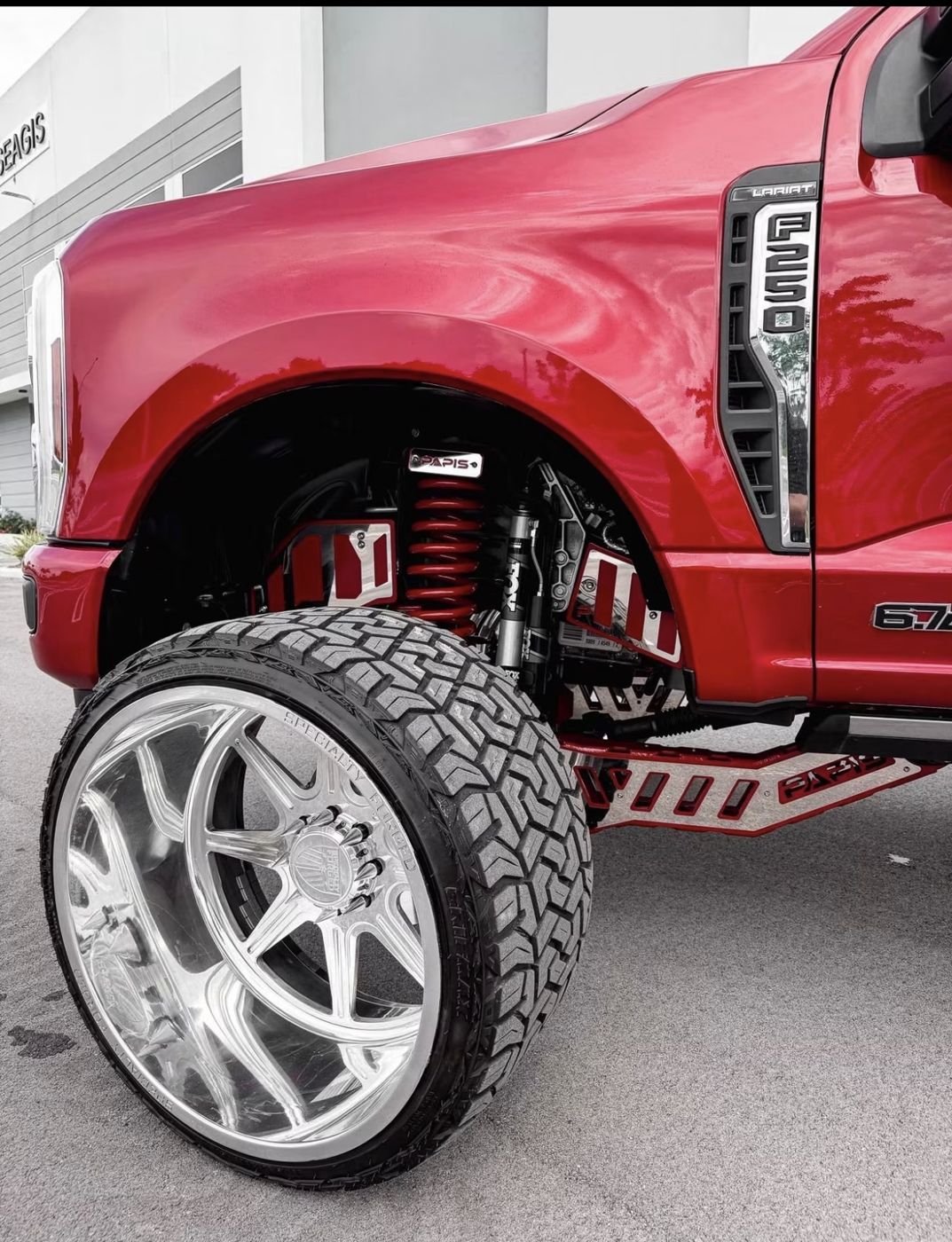 Red powder coated suspension and lift components on a Ford F-250
